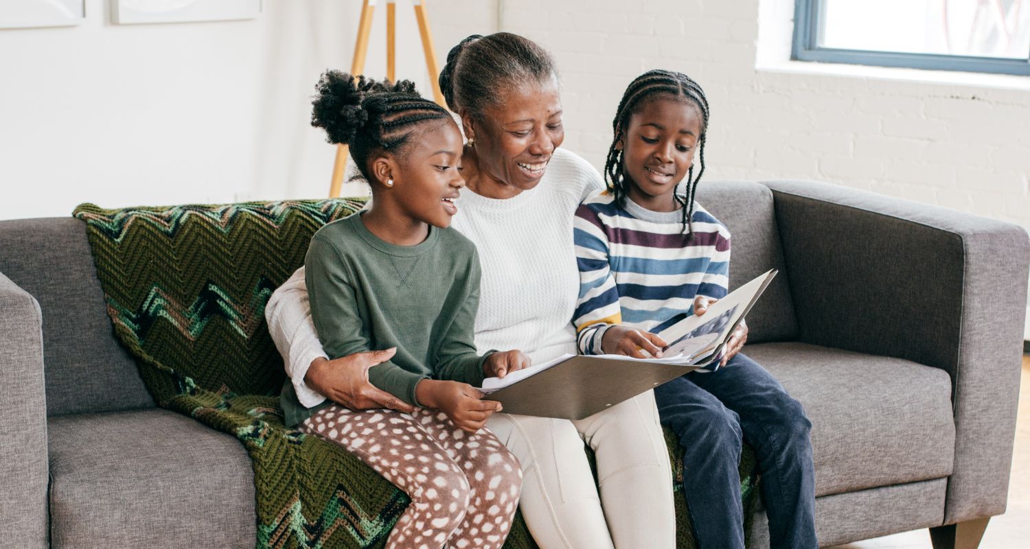 Grandmother and grandkids looking at a book