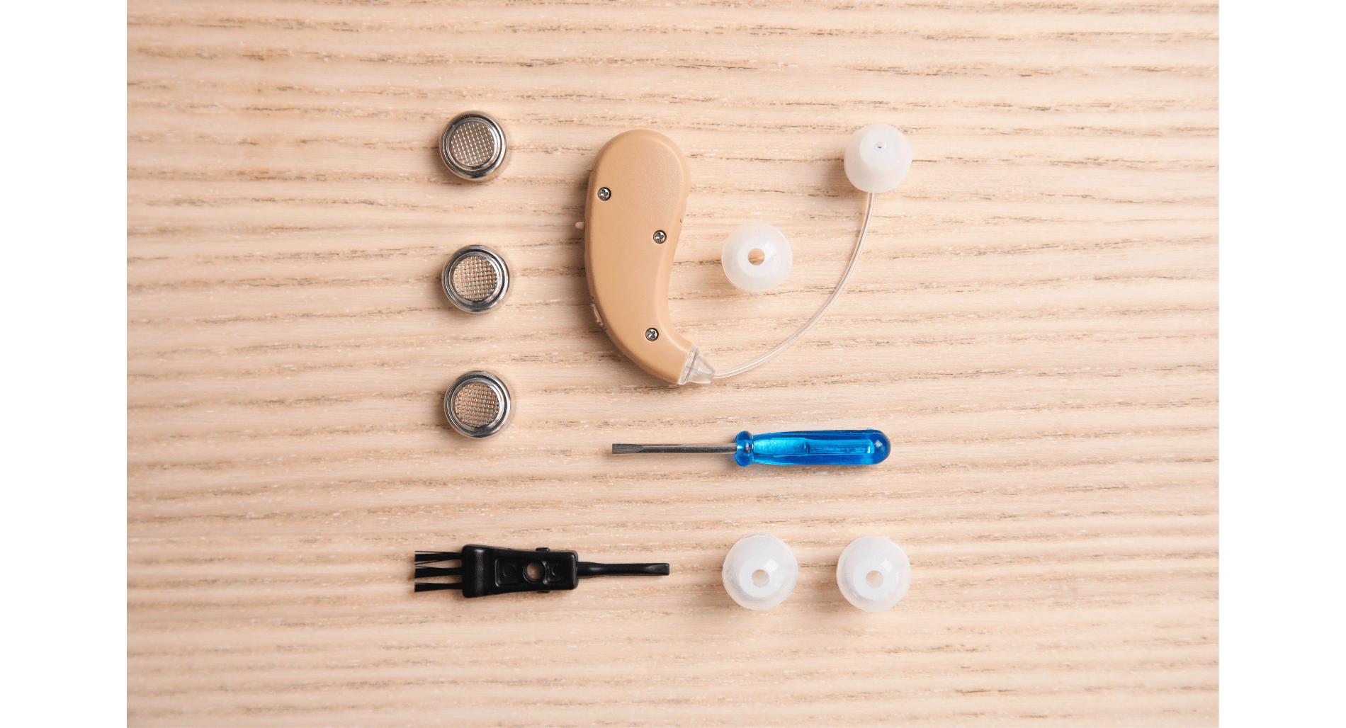 Hearing aid and maintenance tools on table